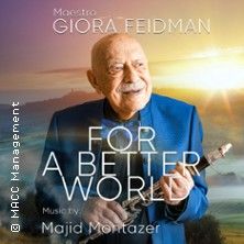 Ein älterer Mann in blauem Anzug hält eine Klarinette vor einem Sonnenuntergang. Text: 'Giora Feidman - For a Better World'.